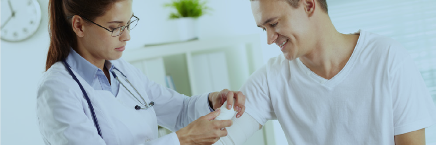 Image showing doctor wrapping gauze around a man's arm.