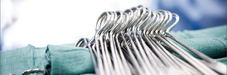 Surgical scissors laying on top of surgery cloths.